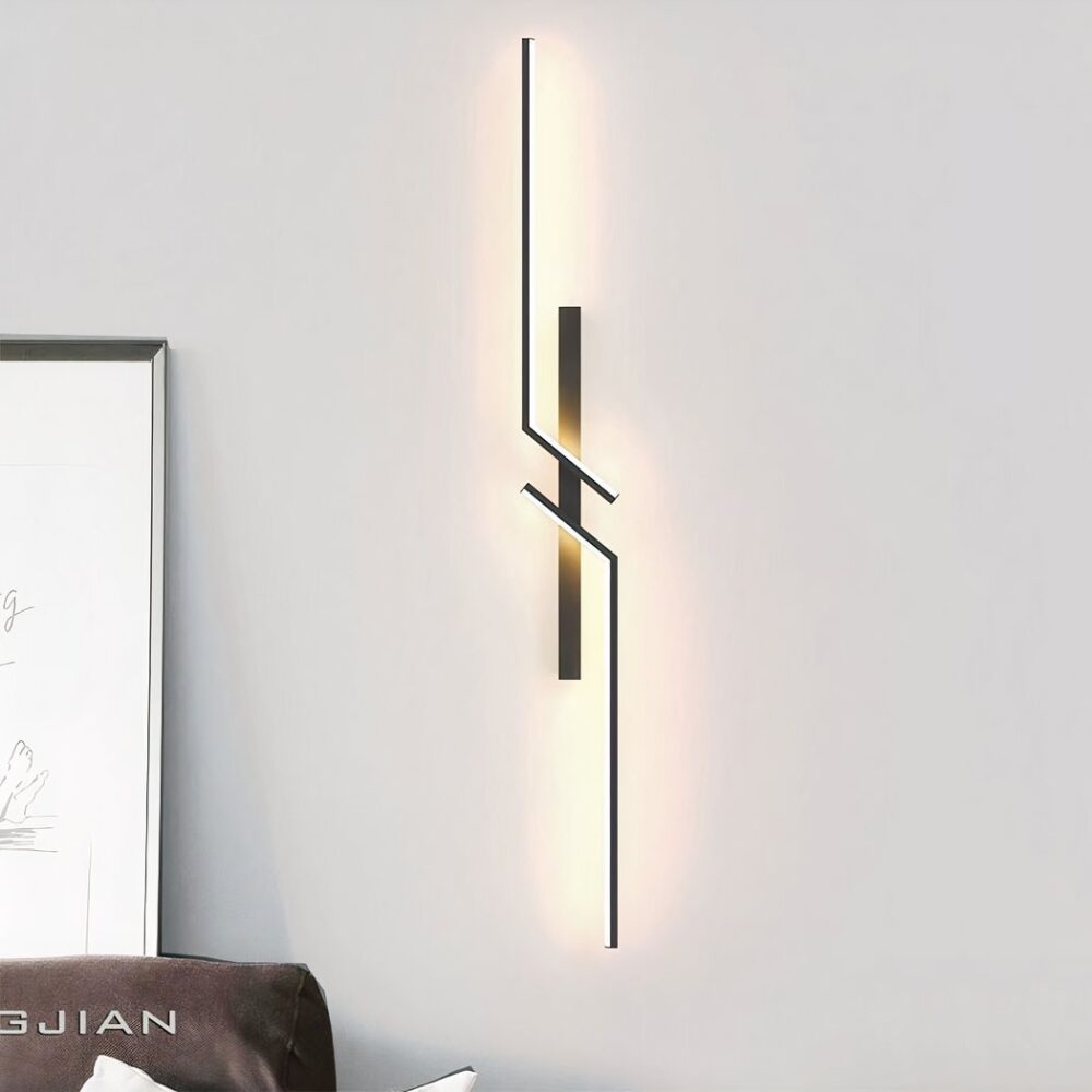 Applique murale noire, géométrique en miroir. accroché sur un mur blanc.