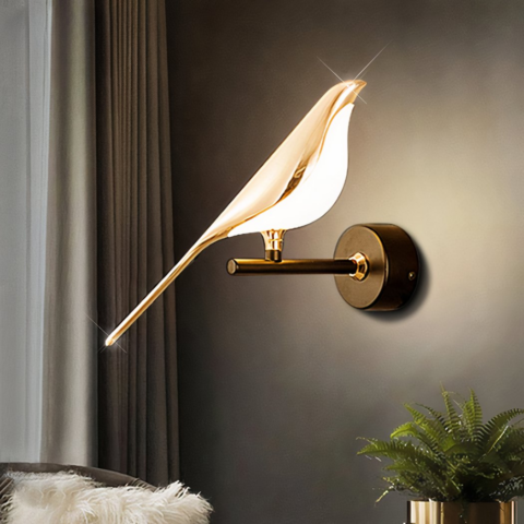 Sur un fond noir, on voit une applique murale dorée en forme d'oiseau au design moderne.