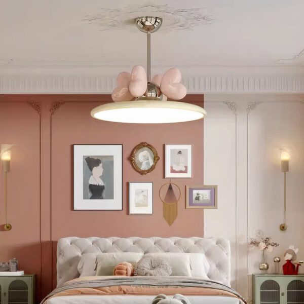 Lustre pour chambre de bébé avec coeurs rose, suspendu au dessus d'un lit