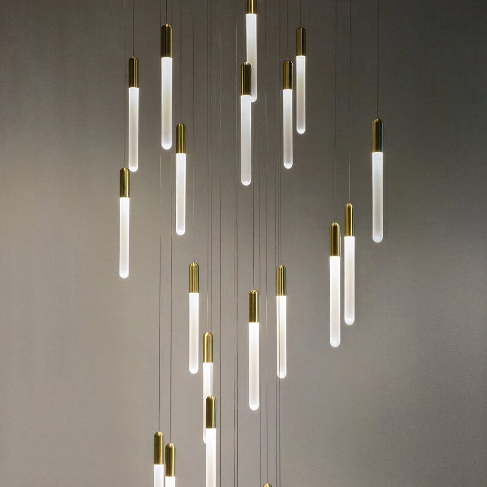 Suspension dorée au design nordique avec vingt-cinq têtes sur fond gris