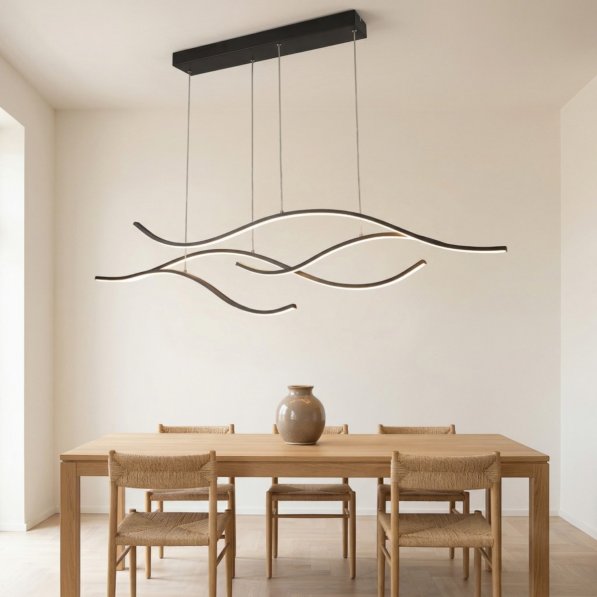 Suspension LED noire en forme de vagues ondulées au-dessus d'une table à manger en bois