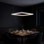 Lustre cadre carré allumé la nuit au-dessus d'une table